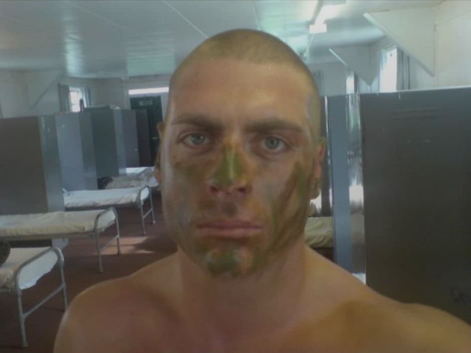 Mark in camouflage face paint in a barracks during Coldstream Guards training, 2009